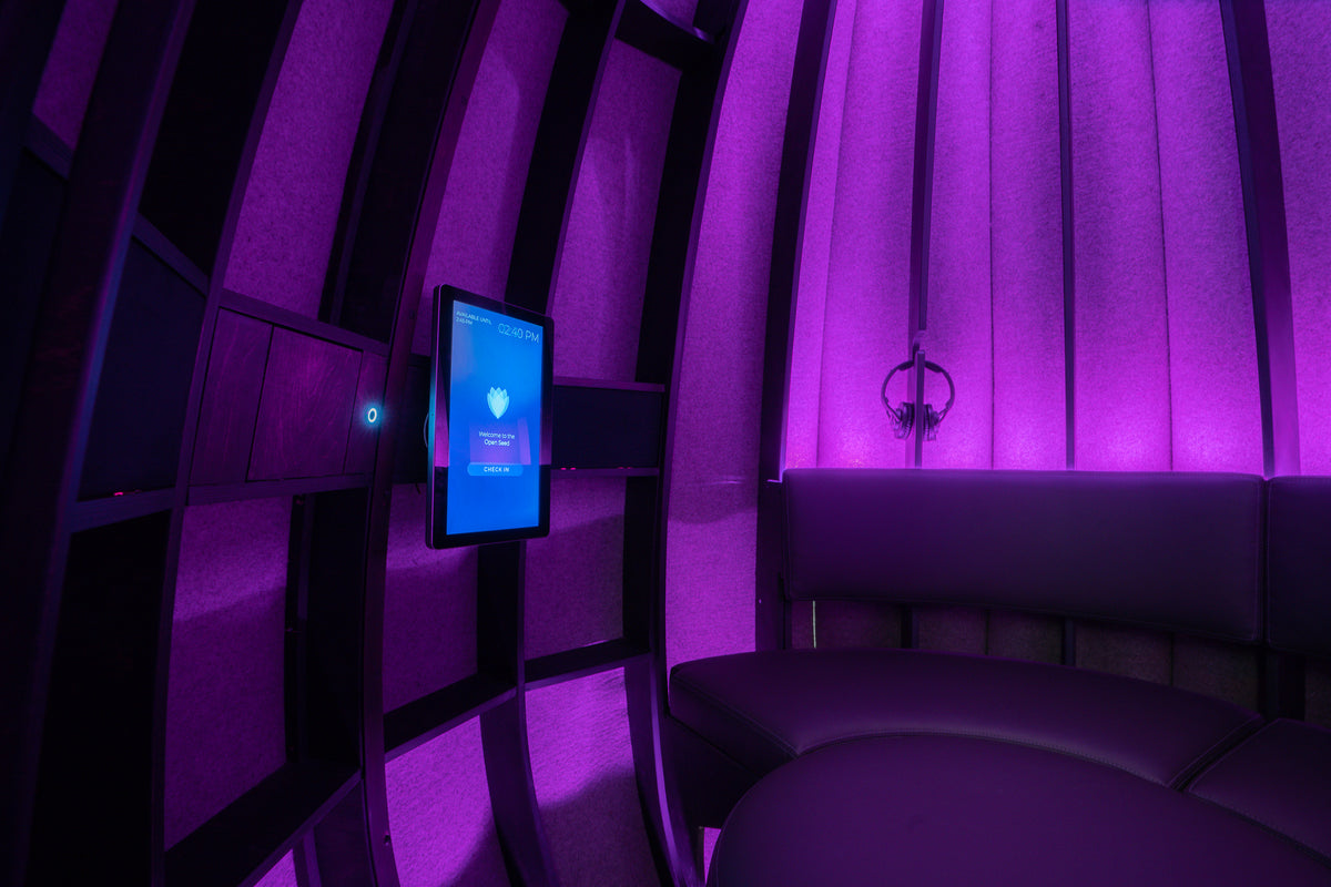 Violet-lit interior of the Lotus meditation pod