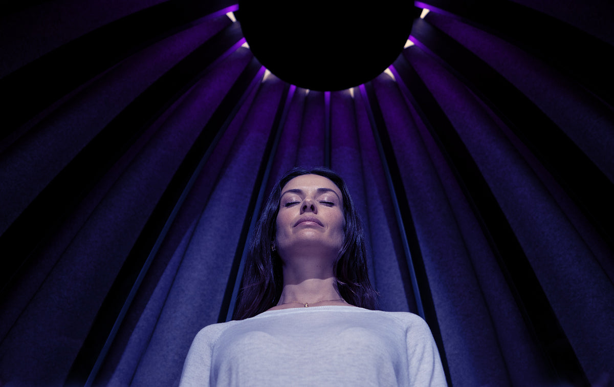 Woman relaxing inside the Lotus pod in violet light