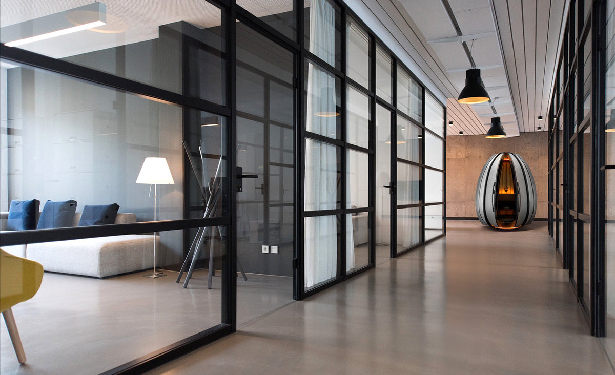 Lotus meditation pod at the end of a modern office corridor